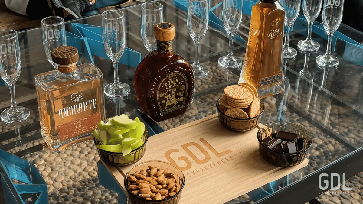 Tequila poured beside a food pairing plate on a premium tequila tour with tastings from Guadalajara
